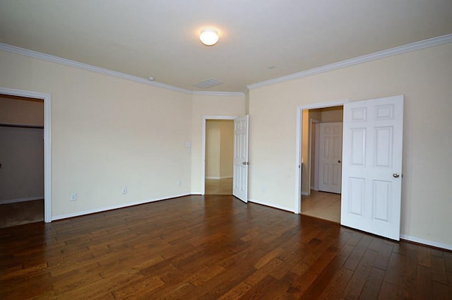4202 Misty Waters Ln, Katy, TX 77494 - unfurnished bedroom with ornamental molding, wood-type flooring, and a walk in closet