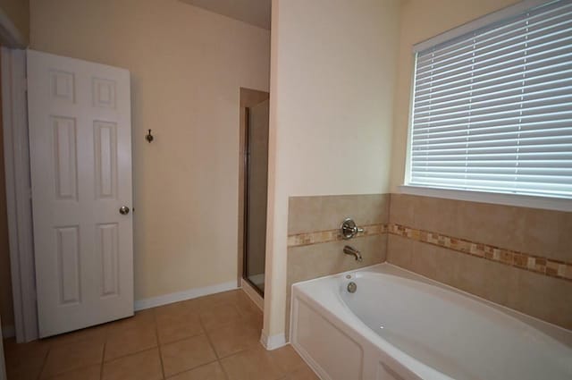 4202 Misty Waters Ln, Katy, TX 77494 - bathroom with tile patterned floors, a bath, and an enclosed shower