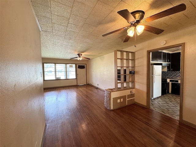 2066 Earl St, Beaumont, TX 77703 - unfurnished living room with a ceiling fan and wood finished floors