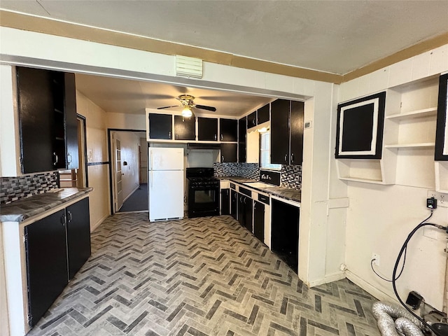 2066 Earl St, Beaumont, TX 77703 - kitchen featuring freestanding refrigerator, black range with gas cooktop, dark cabinetry, and tasteful backsplash