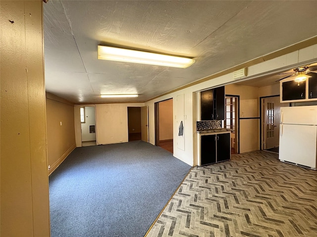 2066 Earl St, Beaumont, TX 77703 - basement featuring freestanding refrigerator, carpet floors, and ceiling fan