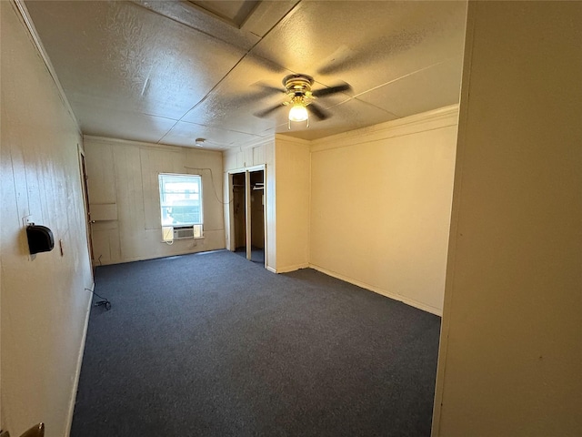 2066 Earl St, Beaumont, TX 77703 - empty room with dark colored carpet, a ceiling fan, a textured ceiling, ornamental molding, and wood walls