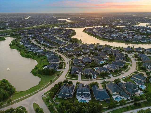 5119 Kendalia Cloud Ln, Fulshear, TX 77441 - aerial view at dusk of a water view and a residential view