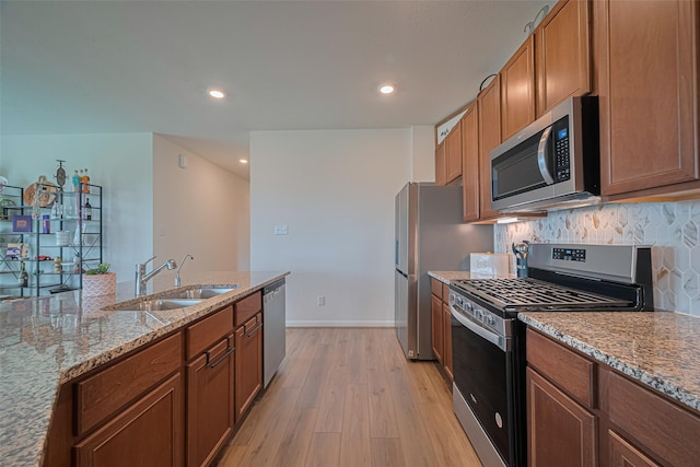7227 Birchville Dr, Rosharon, TX 77583 - kitchen featuring stainless steel appliances, light wood-type flooring, light stone countertops, recessed lighting, and tasteful backsplash