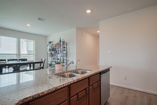7227 Birchville Dr, Rosharon, TX 77583 - kitchen with stainless steel dishwasher, light wood finished floors, light stone countertops, and recessed lighting