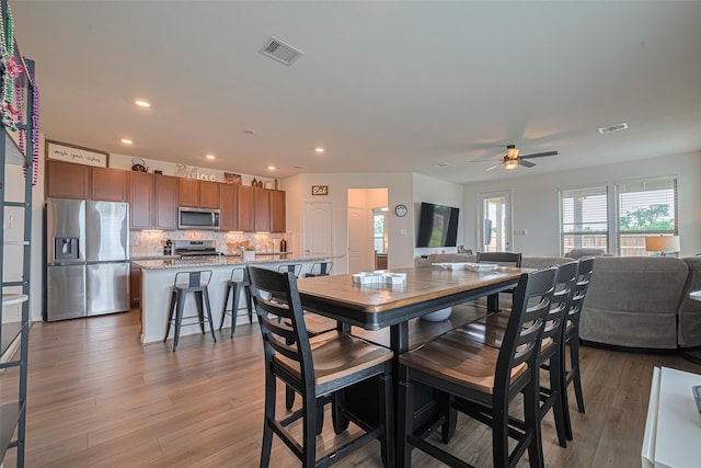 7227 Birchville Dr, Rosharon, TX 77583 - dining space with light wood-type flooring, a ceiling fan, and recessed lighting