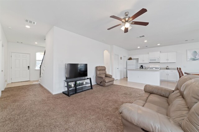 12712 Plummersville St, Houston, TX 77072 - living area featuring arched walkways, ceiling fan, recessed lighting, and light colored carpet