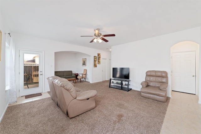 12712 Plummersville St, Houston, TX 77072 - living room with arched walkways, ceiling fan, tile patterned flooring, and carpet floors