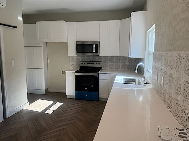 6709 Jensen St, Hitchcock, TX 77563 - kitchen featuring stainless steel appliances, light countertops, white cabinets, and decorative backsplash