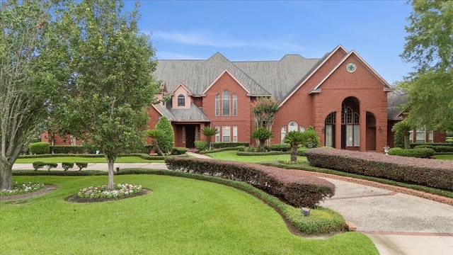 7510 Shadow Creek Dr, Beaumont, TX 77707 - traditional-style home featuring brick siding and a front yard