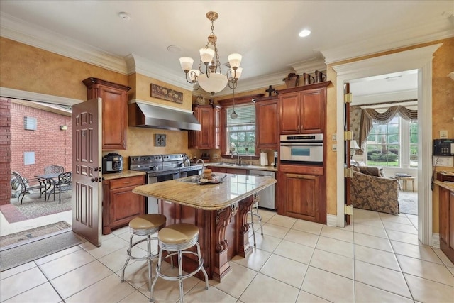 7510 Shadow Creek Dr, Beaumont, TX 77707 - kitchen with stainless steel appliances, wall chimney exhaust hood, a chandelier, healthy amount of natural light, and ornamental molding