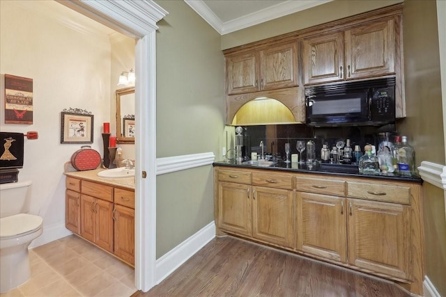 7510 Shadow Creek Dr, Beaumont, TX 77707 - indoor wet bar with black microwave, decorative backsplash, and ornamental molding
