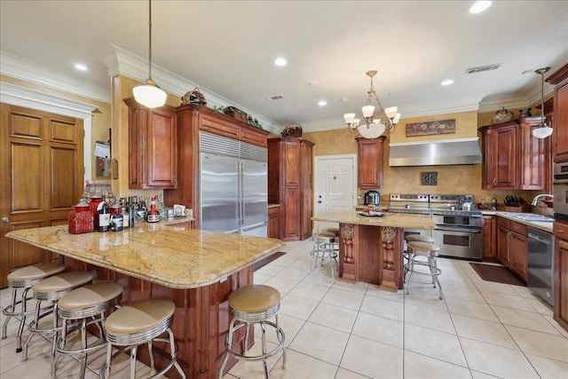 7510 Shadow Creek Dr, Beaumont, TX 77707 - kitchen with appliances with stainless steel finishes, ventilation hood, a breakfast bar area, a peninsula, and crown molding