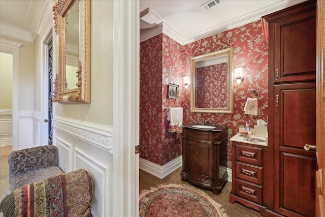 7510 Shadow Creek Dr, Beaumont, TX 77707 - bathroom with vanity, ornamental molding, wainscoting, wallpapered walls, and a decorative wall