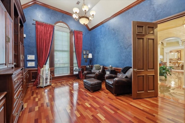7510 Shadow Creek Dr, Beaumont, TX 77707 - living area with wood finished floors, ornamental molding, vaulted ceiling, a textured wall, and a chandelier