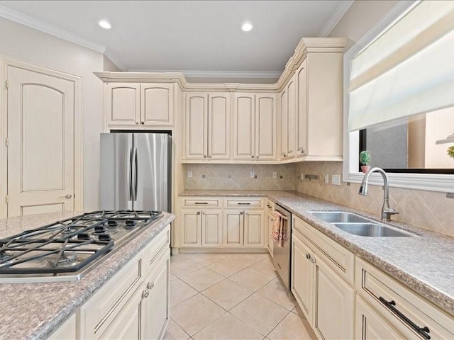 405 Reinerman St, Houston, TX 77007 - kitchen with stainless steel appliances, cream cabinets, ornamental molding, light countertops, and light tile patterned flooring