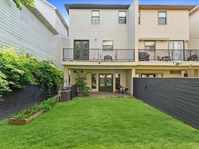 405 Reinerman St, Houston, TX 77007 - rear view of house featuring french doors, stucco siding, a fenced backyard, and a balcony
