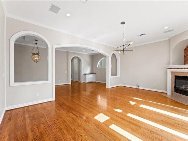 405 Reinerman St, Houston, TX 77007 - unfurnished living room featuring a chandelier, a fireplace with flush hearth, ornamental molding, light wood finished floors, and recessed lighting