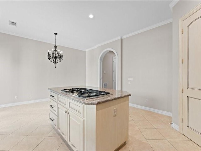 405 Reinerman St, Houston, TX 77007 - kitchen featuring stainless steel gas stovetop, arched walkways, light tile patterned floors, ornamental molding, and hanging light fixtures