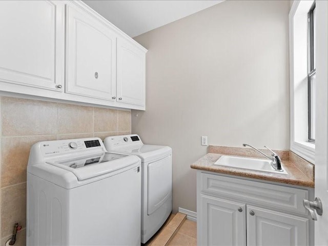 405 Reinerman St, Houston, TX 77007 - laundry room featuring washer and clothes dryer, cabinet space, and light tile patterned floors
