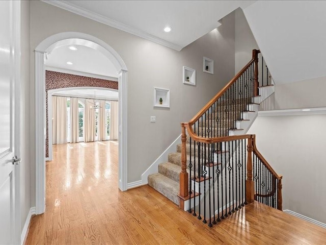 405 Reinerman St, Houston, TX 77007 - stairs with arched walkways, wood finished floors, crown molding, decorative columns, and recessed lighting