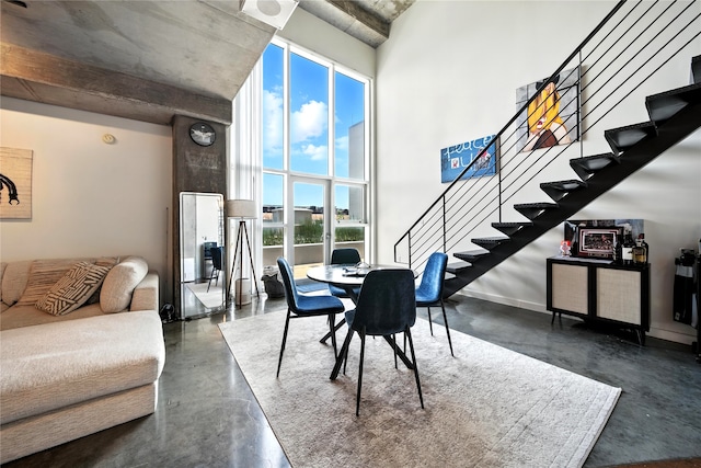 2000 Bagby St Unit 5423, Houston, TX 77002 - dining area featuring finished concrete flooring, stairway, and a towering ceiling
