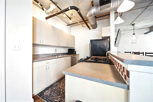 2000 Bagby St Unit 5423, Houston, TX 77002 - kitchen featuring refrigerator, stainless steel dishwasher, stove, hanging light fixtures, and white cabinetry