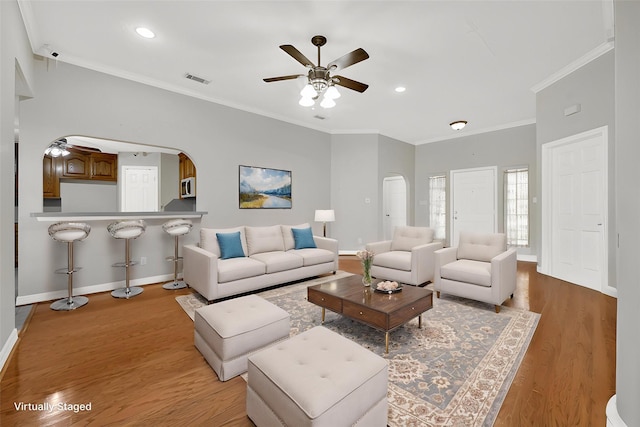 13314 Kaylee Ln, Santa Fe, TX 77510 - living area featuring arched walkways, ceiling fan, light wood-style floors, crown molding, and recessed lighting
