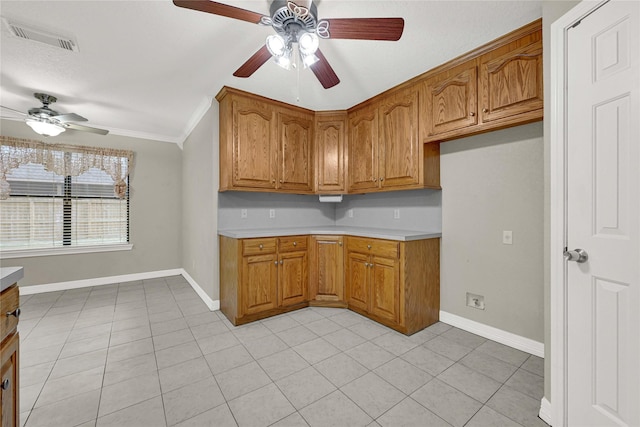 13314 Kaylee Ln, Santa Fe, TX 77510 - kitchen with a ceiling fan, brown cabinetry, ornamental molding, light tile patterned flooring, and light countertops
