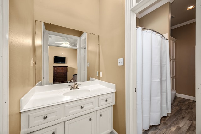 13722 Vinery Ln, Cypress, TX 77429 - bathroom with vanity, wood finished floors, a ceiling fan, and crown molding