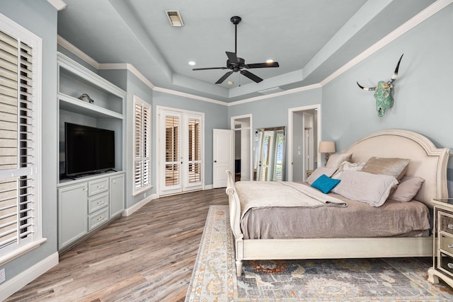 13722 Vinery Ln, Cypress, TX 77429 - bedroom featuring a tray ceiling, wood finished floors, recessed lighting, access to outside, and ornamental molding