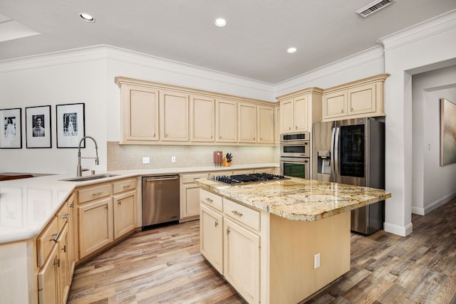 13722 Vinery Ln, Cypress, TX 77429 - kitchen with appliances with stainless steel finishes, light wood-type flooring, decorative backsplash, crown molding, and a center island