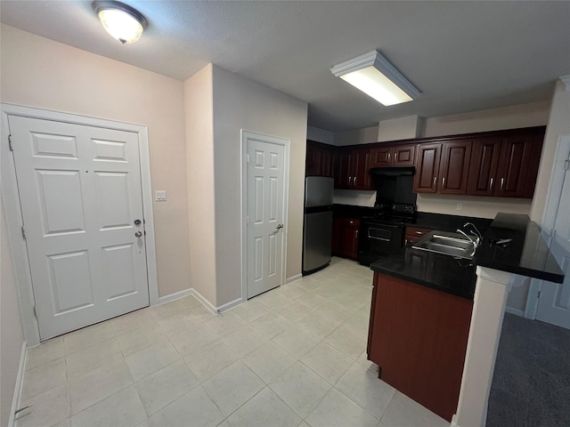 6633 W Sam Houston Pkwy S Unit 1A, Houston, TX 77072 - kitchen with freestanding refrigerator, black electric range, dark countertops, a peninsula, and dark brown cabinets