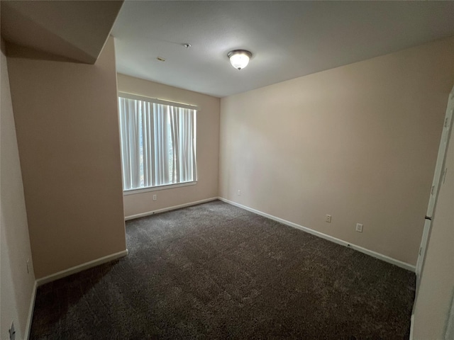 6633 W Sam Houston Pkwy S Unit 1A, Houston, TX 77072 - empty room featuring dark colored carpet and baseboards