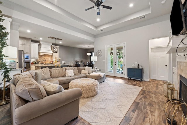 2619 Portland Ave, College Station, TX 77845 - living area featuring a ceiling fan, wood finished floors, recessed lighting, a fireplace, and a tray ceiling