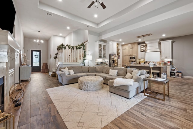 2619 Portland Ave, College Station, TX 77845 - living room with stairway, light wood-style floors, recessed lighting, a ceiling fan, and a chandelier