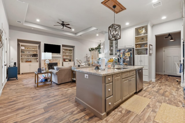 2619 Portland Ave, College Station, TX 77845 - kitchen with stainless steel appliances, a ceiling fan, open shelves, a center island with sink, and a tray ceiling
