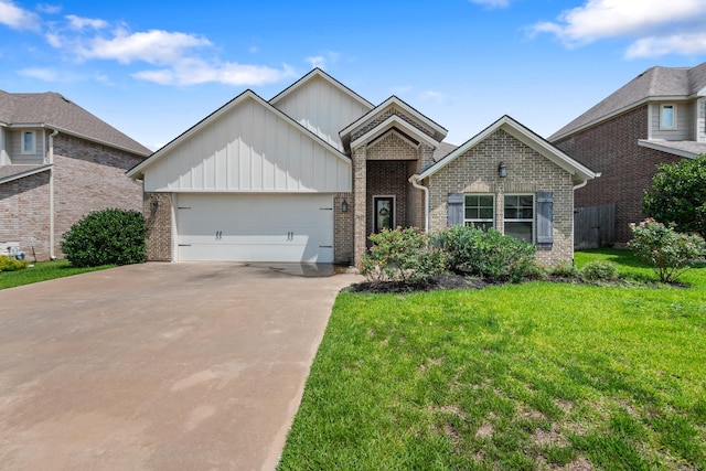 2619 Portland Ave, College Station, TX 77845 - view of front of home with board and batten siding, an attached garage, concrete driveway, a front yard, and brick siding