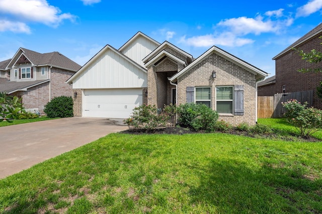 2619 Portland Ave, College Station, TX 77845 - view of front of home featuring a garage, board and batten siding, concrete driveway, and brick siding