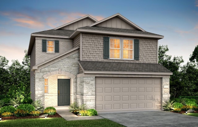 16424 Windy Cove Ct, Conroe, TX 77378 - view of front of property featuring stone siding, board and batten siding, a garage, concrete driveway, and a shingled roof