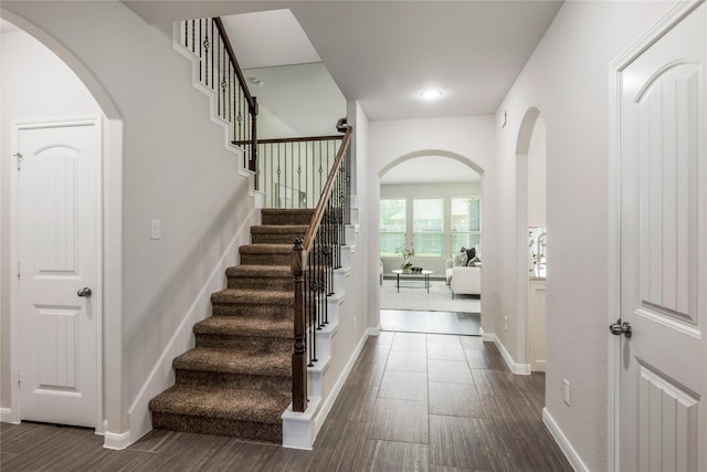 18723 Pilot Knolls Dr, Cypress, TX 77433 - stairway featuring wood finished floors, arched walkways, and recessed lighting