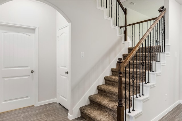 18723 Pilot Knolls Dr, Cypress, TX 77433 - stairs featuring arched walkways and wood finished floors
