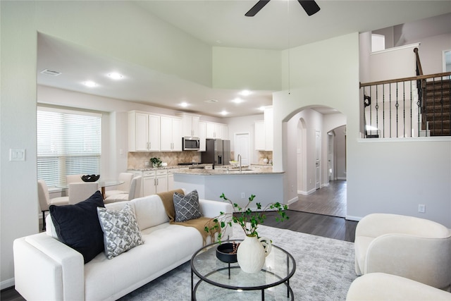 18723 Pilot Knolls Dr, Cypress, TX 77433 - living area featuring ceiling fan, a high ceiling, dark wood-style floors, recessed lighting, and arched walkways