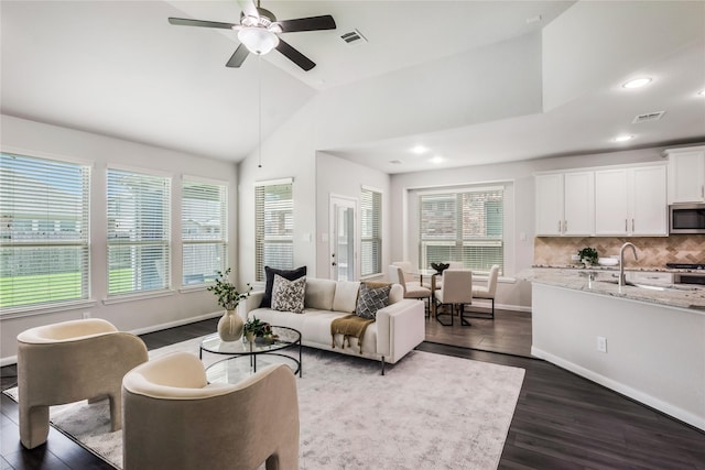 18723 Pilot Knolls Dr, Cypress, TX 77433 - living room featuring dark wood finished floors, plenty of natural light, vaulted ceiling, a ceiling fan, and recessed lighting
