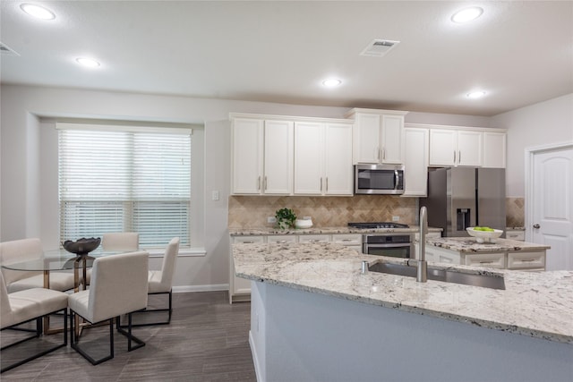 18723 Pilot Knolls Dr, Cypress, TX 77433 - kitchen with stainless steel appliances, white cabinets, backsplash, dark wood-style flooring, and recessed lighting