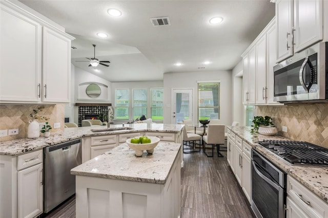 18723 Pilot Knolls Dr, Cypress, TX 77433 - kitchen with stainless steel appliances, a peninsula, ceiling fan, white cabinets, and recessed lighting