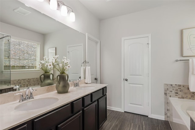 18723 Pilot Knolls Dr, Cypress, TX 77433 - bathroom with a garden tub, double vanity, and wood finished floors