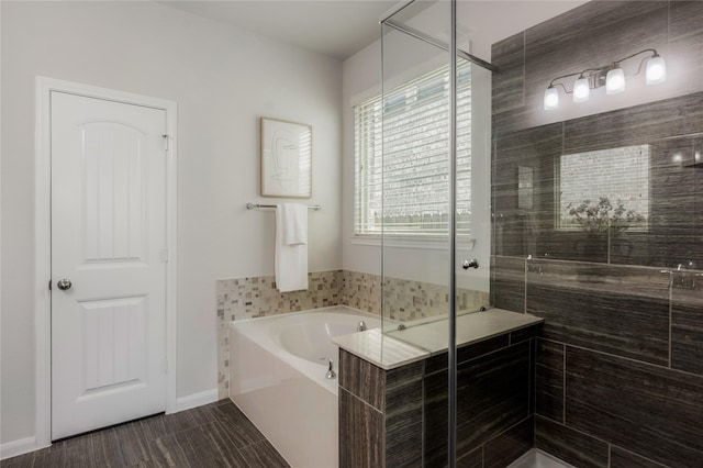 18723 Pilot Knolls Dr, Cypress, TX 77433 - bathroom with a garden tub, a stall shower, and wood finished floors