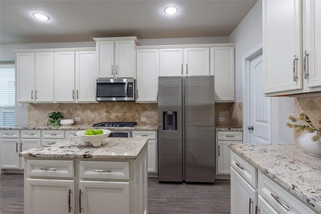 18723 Pilot Knolls Dr, Cypress, TX 77433 - kitchen featuring appliances with stainless steel finishes, white cabinetry, dark wood-style floors, decorative backsplash, and recessed lighting