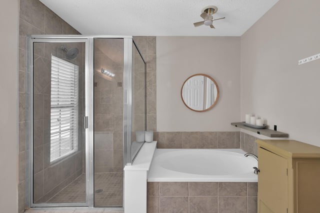 17214 Shadow Valley Dr, Spring, TX 77379 - bathroom featuring ceiling fan, a bath, and a shower stall